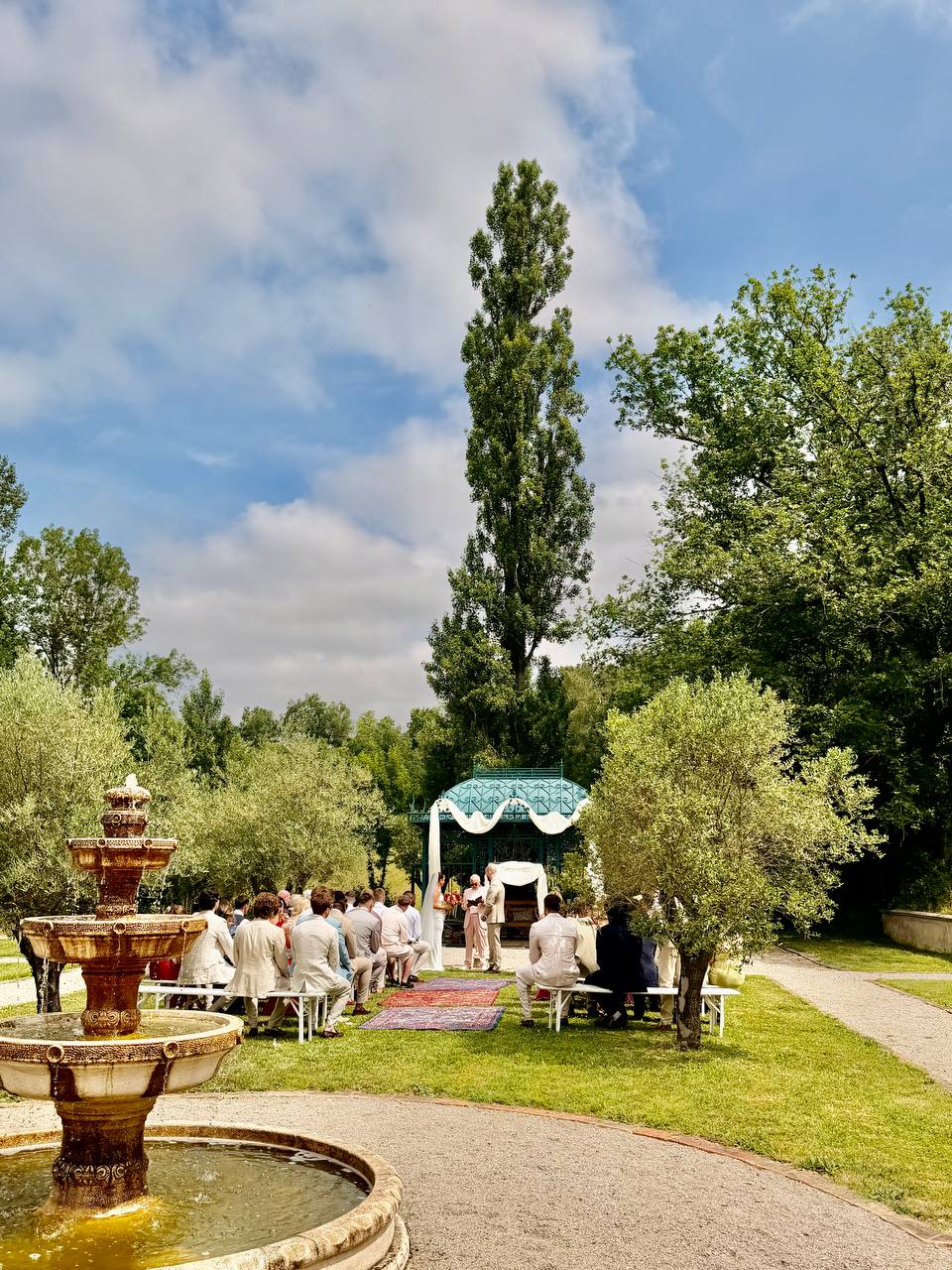 Wedding ceremony at the iron pavilion beside the fountain in the formal gardens at Les Cazettes